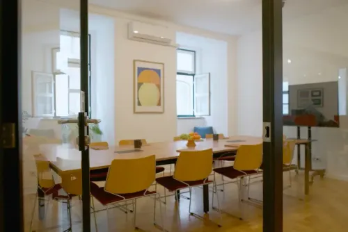 Parquet-Floored Boardroom With White Walls and Mid-Century Chairs for Strategy Sessions