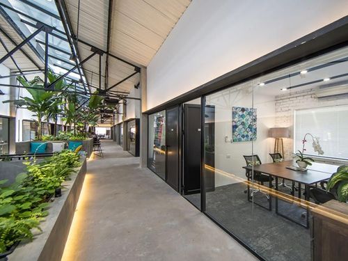 Modern Industrial Office With Lush Greenery for Dynamic Meetings