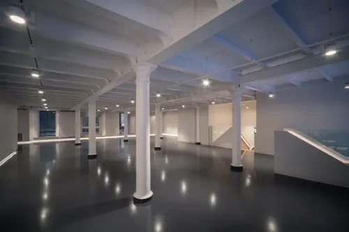 Gallery With Sleek Black Flooring and Flexible Layout for Brand Launches and Exhibitions. Unit X: The Stables. Ground Floor Gallery