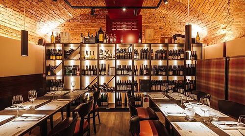 Vaulted Brick Cellar Dining Room With Wine Wall for Private Tastings