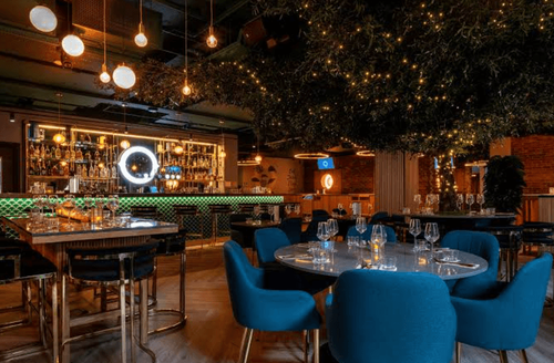 Scandinavian-Inspired Restaurant With Lush Green Foliage for Energetic Mixers